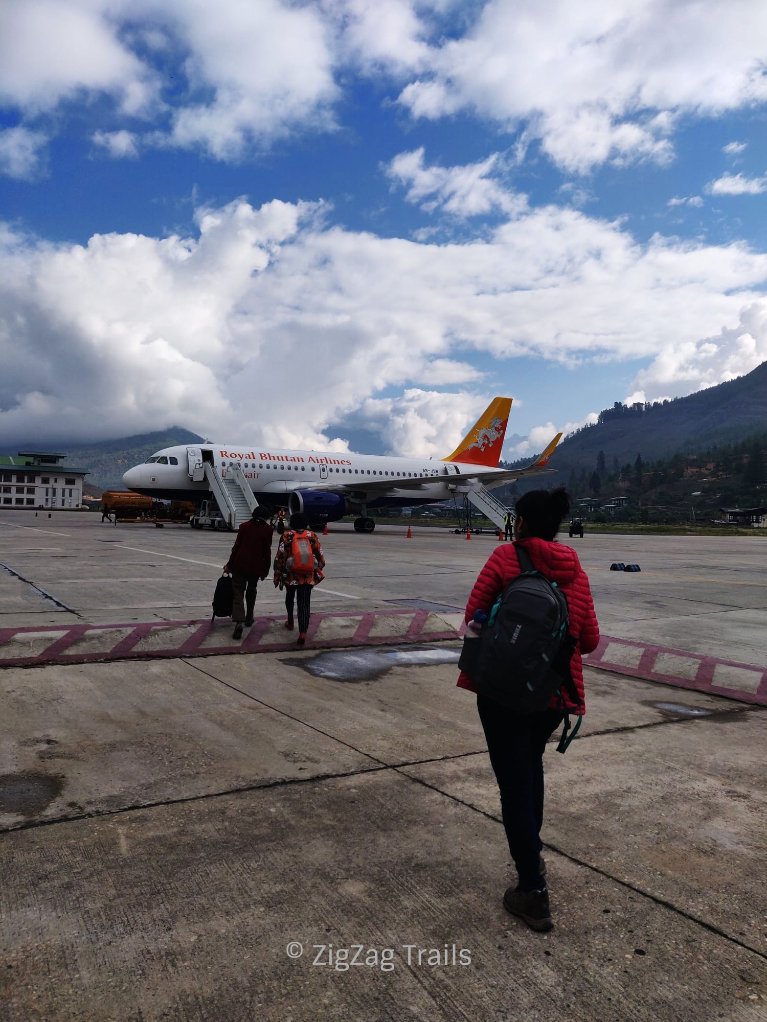 Walking to board the plain at Paro airport, DrukAir.