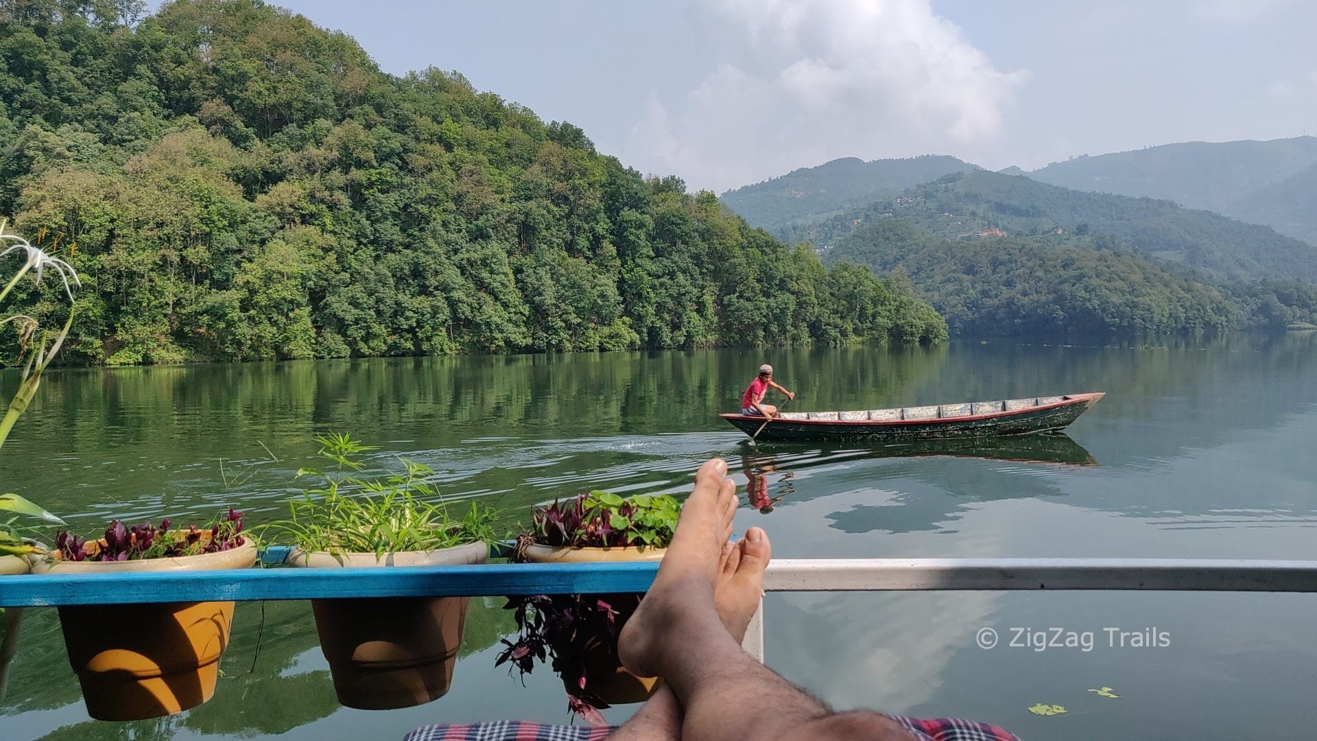 A woman rowing boat in Begnas Lake as seen from Sanu Lake on D water.
