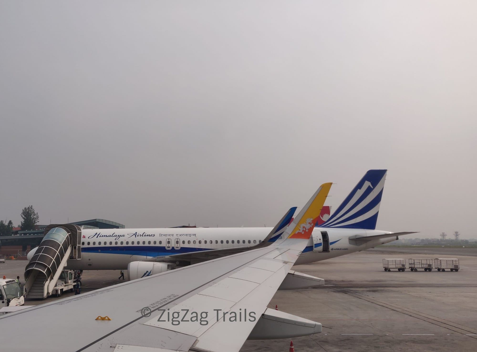 The landing at Kathmandu Airport, grey sky covered with smog.